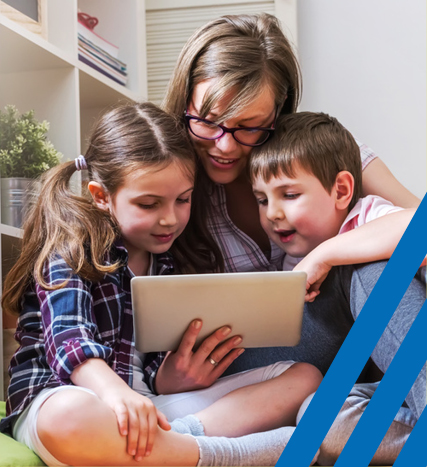 Mother reading a book to two children 